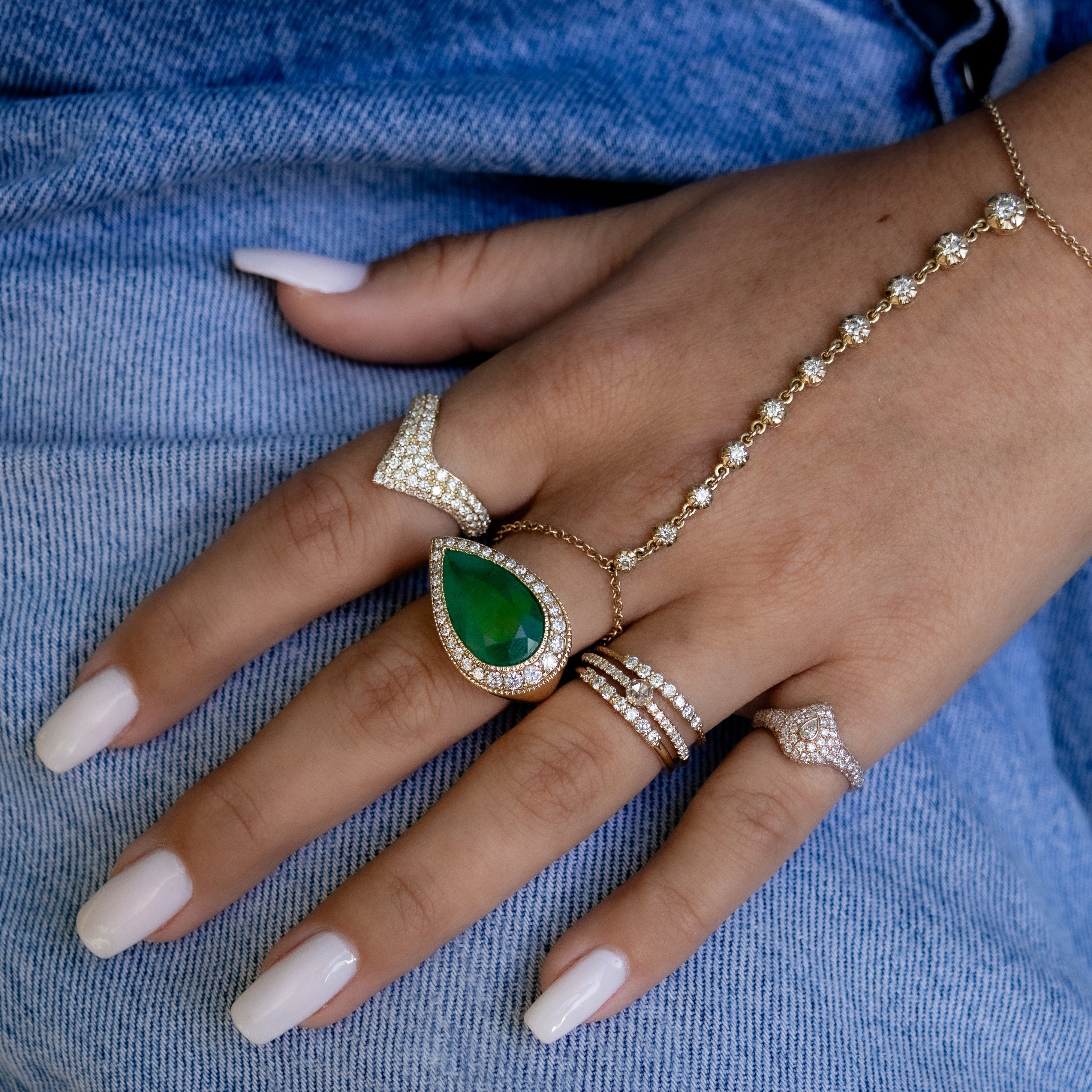 GRADUATED PAVE SIDEWAY EMERALD TEARDROP RING